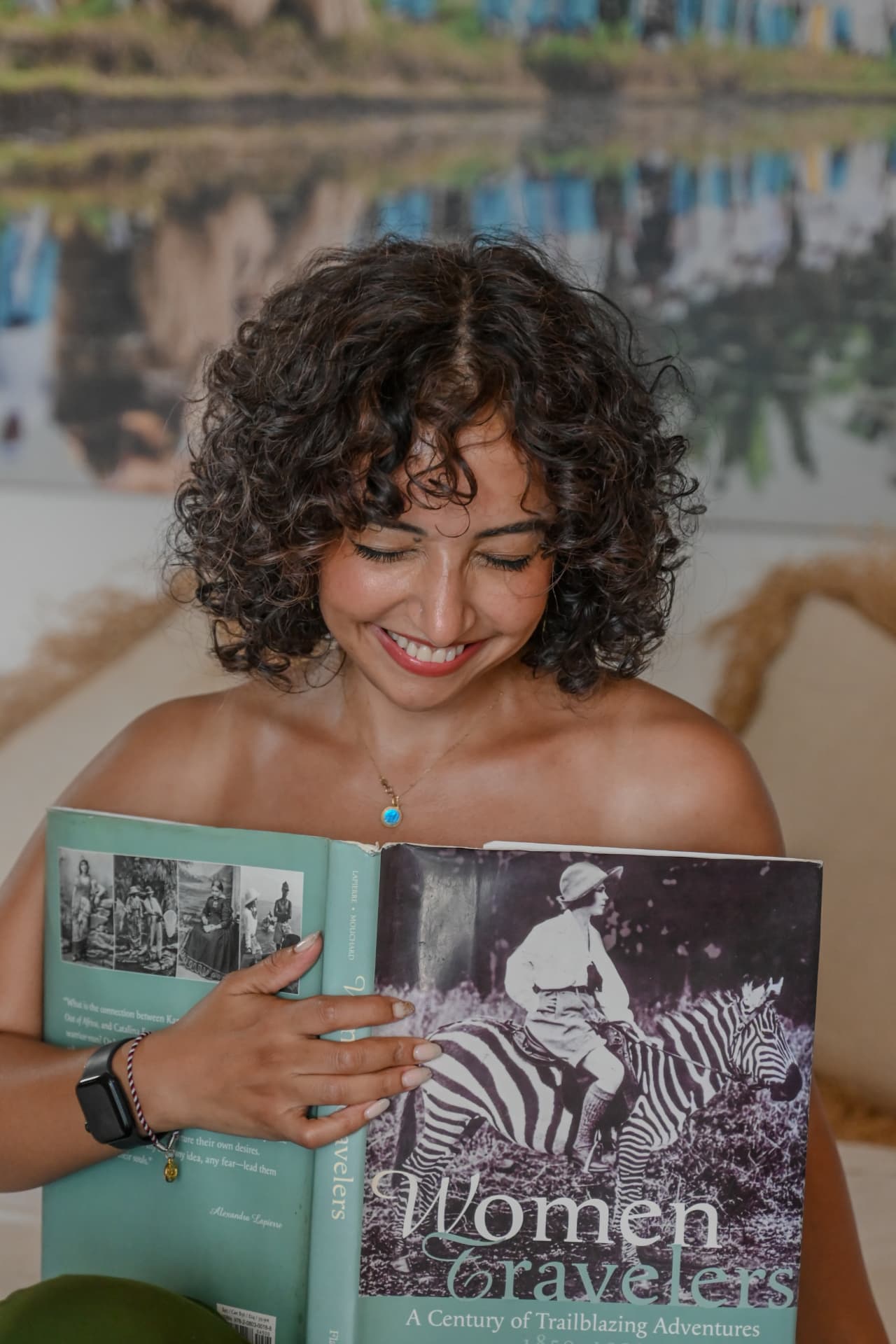 Woman reading a book during a relaxed lifestyle portrait session at a Bali villa