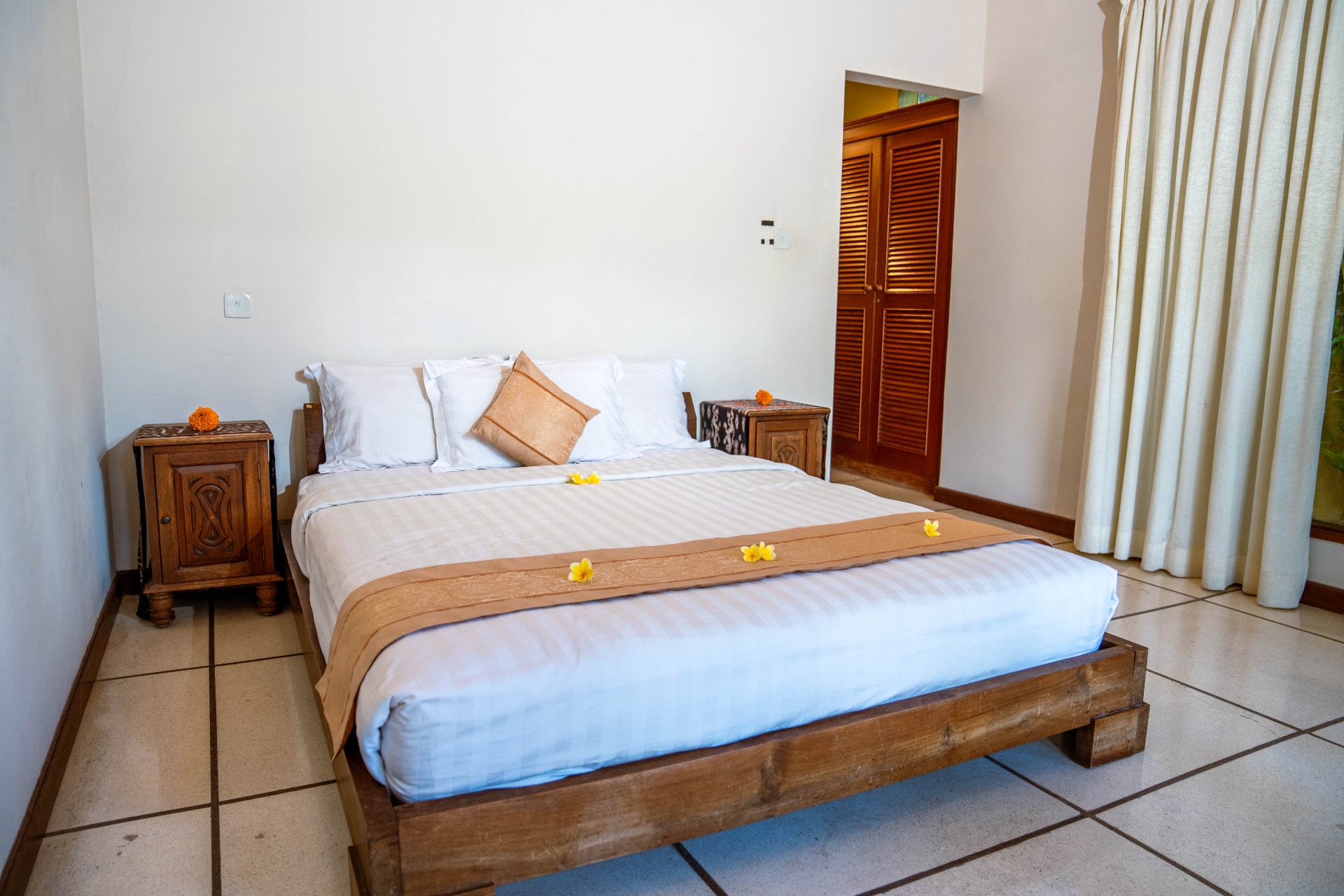 Villa master bedroom with frangipani styling shot for a Bali property listing