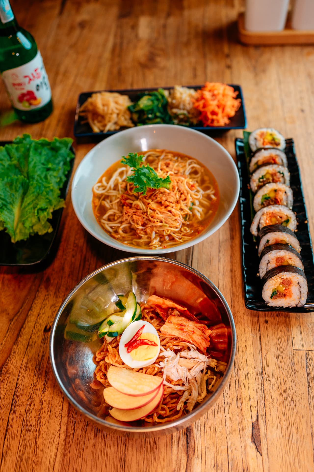 Korean cold noodles, kimbap and banchan shot for a restaurant menu in Bali