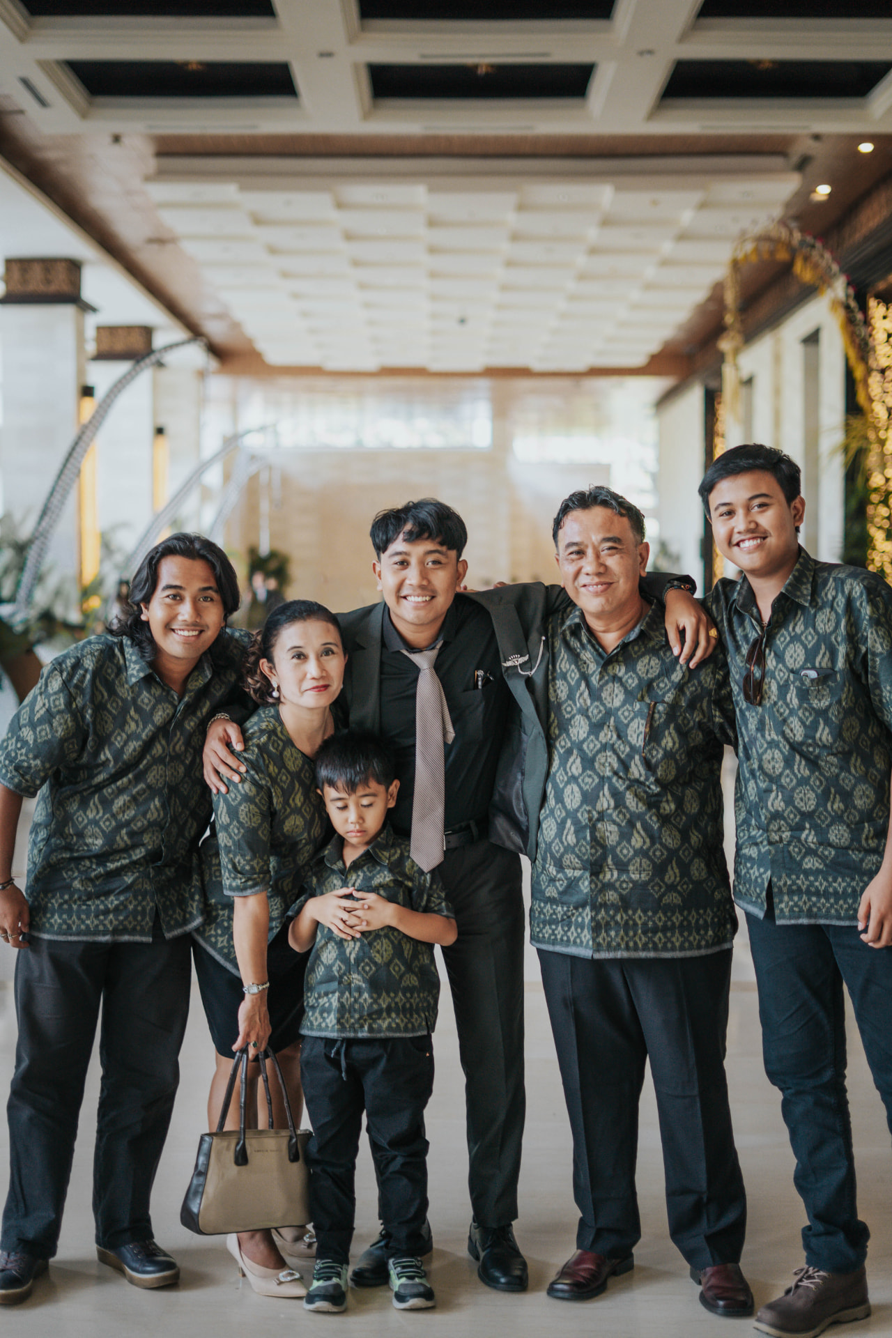 Bali family holiday photo — multi-generation family group in matching batik outfits